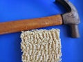Ramen noodles next to the hammer - concept to fix anything using noodles - blue background Royalty Free Stock Photo