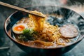 Ramen noodles picked up with chopsticks