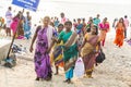 In the main street, Unidentified Hindu pilgrims people ready to go to the temple by walking, after the bath at the gate. Great tim