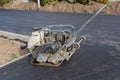 Ramming vibrating machine on a freshly laid asphalt surface. Vibratory plate compactor Royalty Free Stock Photo
