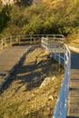 Ramp for wheel chairs in wooded area for walking and traveling by pedestrians with the dog on outdoor expeditions