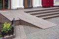 Ramped access, using wheelchair ramp for disabled people. Royalty Free Stock Photo