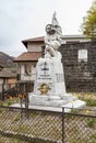 War memorial with memorial stone, figure of a soldier kissing the flag in Rampino Verna, province of Como, Italy