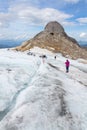 People hiking on Gjaidstein Mountain adventure trail near Dachstein glacier on August 17, 2017 in Ramsau am Dachstein, Austria.