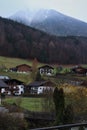 Fog over mountain in the Alps behind village