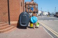 Ramsgate, UK - June 24 2020 A family walk along a pavement heading to the beach carrying an inflateable dinghy and beach equipment