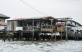 Ramshackle house of poor family on the water Royalty Free Stock Photo