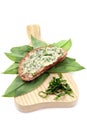 Ramson butter on slice of brown bread with fresh leaves. Royalty Free Stock Photo