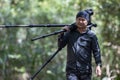 Local Young man traveler with carrying photography gear to taking photo of wildlife on Rainforest jungle