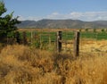 Ranch fence and gate on scenic farmland