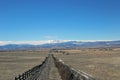 A ranch fence leading up to the rockies Royalty Free Stock Photo