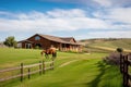 ranch house exterior, with view of rolling hills and pastures filled with horses