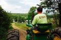 A ranch work drives his tractor on the farm Royalty Free Stock Photo