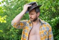 rancher man in cowboy hat. sexy cowboy in checkered shirt. western cowboy wearing hat Royalty Free Stock Photo