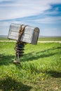 A rancherÃ¢â¬â¢s old metal mailbox with a bridle wrapped around it in rural Saskatchewan, Canada Royalty Free Stock Photo