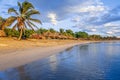 Rancho Luna caribbean beach with palms and straw umbrellas on the shore, Cienfuegos, Cuba Royalty Free Stock Photo