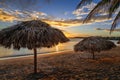 Rancho Luna caribbean beach with palms and straw umbrellas on the shore, sunset view, Cienfuegos, Cuba Royalty Free Stock Photo