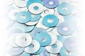 Random arrangement of silver blue grey DVD and CD data storage disks