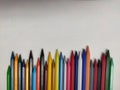Random arrangement of crayon colors on white background.
