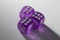 A random arrangement of purple dice and a puzzle cup, captured after the dice have been cast Royalty Free Stock Photo