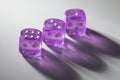 A random arrangement of purple dice and a puzzle cup, captured after the dice have been cast Royalty Free Stock Photo