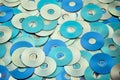 Random arrangement of metallic DVD and CD data storage disks Royalty Free Stock Photo