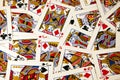 Random playing cards of kings, queens and jacks together forming a background Royalty Free Stock Photo