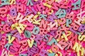 Random colorful letterpress alphabet top view on pink background Royalty Free Stock Photo