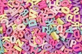 Random colorful letterpress alphabet top view on purple background Royalty Free Stock Photo