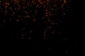 Random flying red orange color particles isolated on the black background, for overlay abstract design