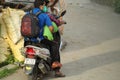 Random peoples are riding motor bike wearing face mask during covid-19 with selective focus, back view