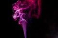 random shapes of colored smoke fired with colored flash red, purple and magenta