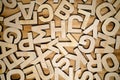 Random wooden block letters lying on wooden background. Top view