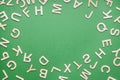 random wooden letter frame on green paper background