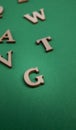 Random wooden letters isolated on green Royalty Free Stock Photo