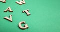 Random wooden letters isolated on green Royalty Free Stock Photo