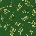 Random yellow leaf branches seamless doodle pattern. Green background. Foliage doodle backdrop