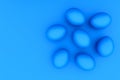 Randomly lying eggs on a blue background, Easter symbol, abstract background, toning.