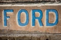 RANDSBURG, CALIFORNIA: An old rusted Ford sign in blue and brown, close up view
