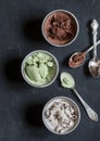 Range of coconut milk ice cream with chocolate, matcha powder, chocolate chips and vanilla. On a dark background, top view. Gluten