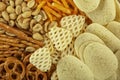 Range of salty snacks, as background. Pretzels, potato chips, crackers and salty straw Royalty Free Stock Photo