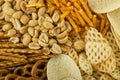 Range of salty snacks, as background. Pretzels, potato chips, crackers and salty straw Royalty Free Stock Photo