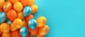 range and turquoise festive ballons on a turquoise background. Banner, copy space.