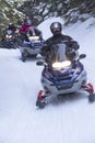 Snowmobilers ride on a trail on Bald Mountain, Rangeley, Maine.