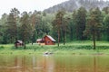 Small house in the forest on the river Bank