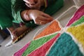 Woman making a rangoli on the occasion of Diwali