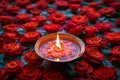 Rangoli elegance red rose floral design with a lit diya Royalty Free Stock Photo