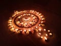 Rangoli with flowers and Diya.