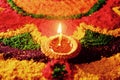 Rangoli with glowing oil lamp