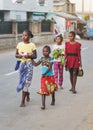 Ranohira, Madagascar - April 29, 2019: Group of four unknown young Malagasy girls wearing bright coloured clothes walking barefoot Royalty Free Stock Photo